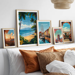 Maui Hawaii Travel Poster | Sunny Surfing Beach Wall Art Print displayed among other travel posters on a cozy sofa.