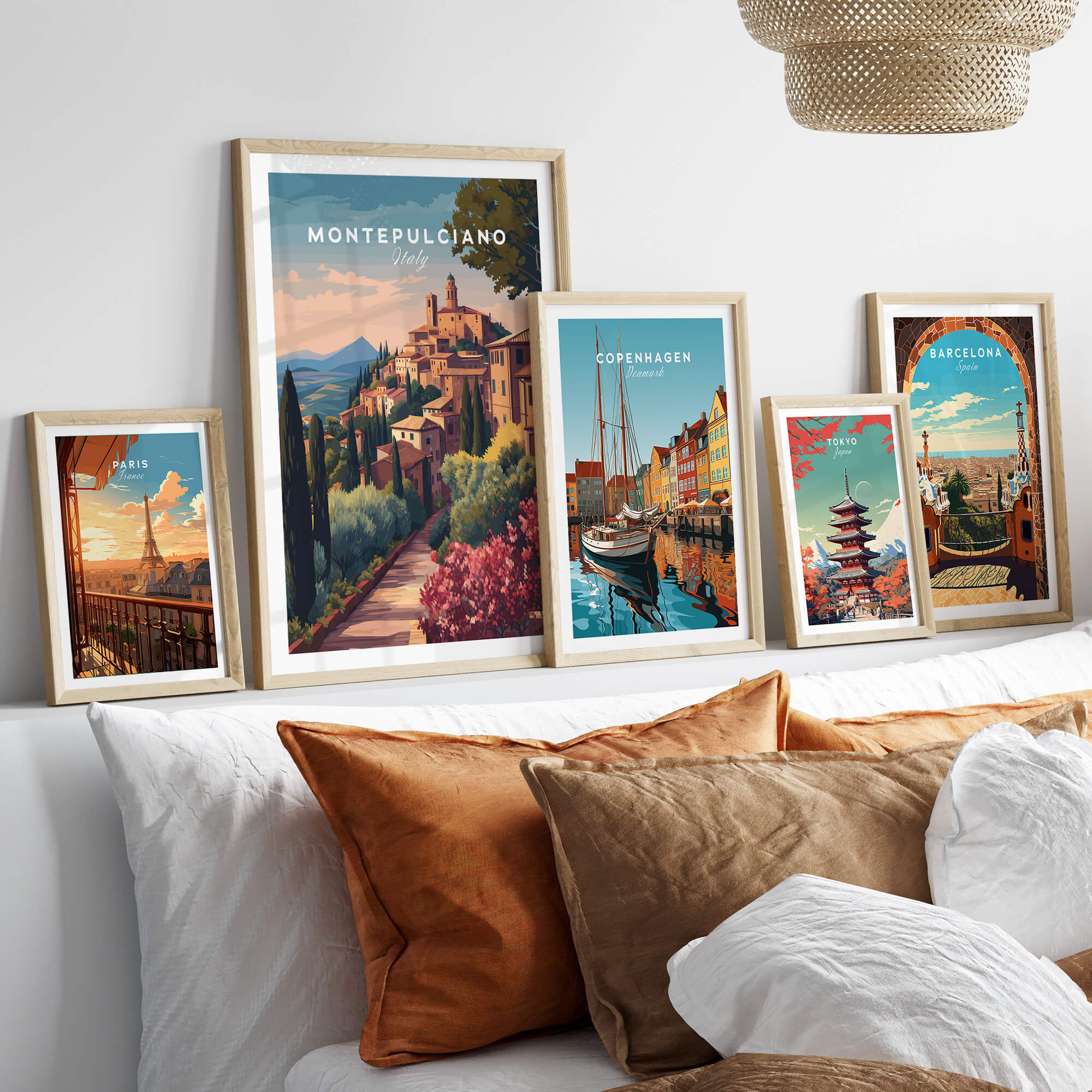Montepulciano Italy Travel Poster | Tuscan Sunset Wall Art Print displayed among other travel posters on a stylish sofa.