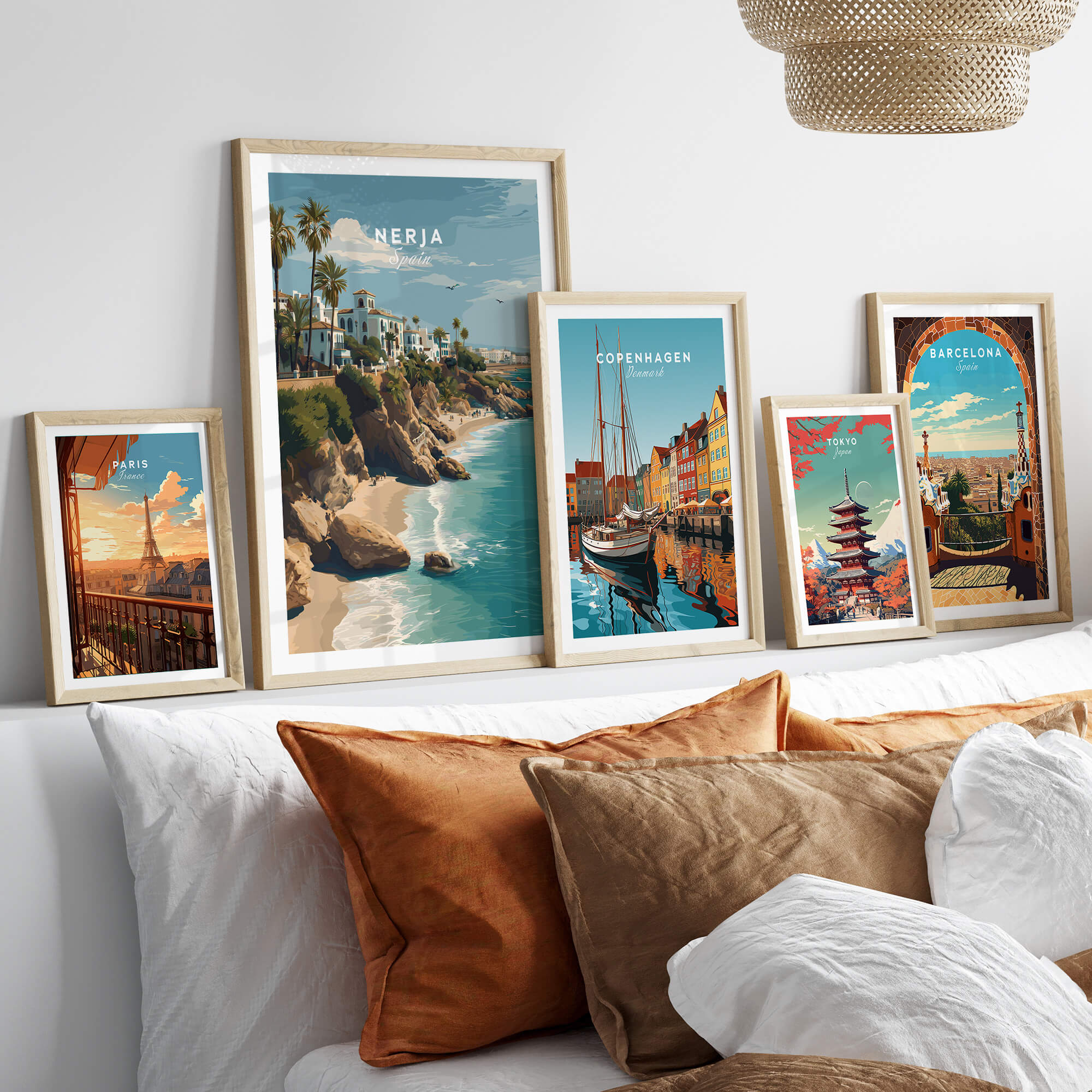 Nerja Spain Wall Art Print | Mediterranean Travel Poster displayed among other travel posters on a stylish couch.