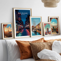 New Orleans Travel Poster | Bourbon Street Night Wall Art Print displayed among other city travel posters on a cozy sofa.