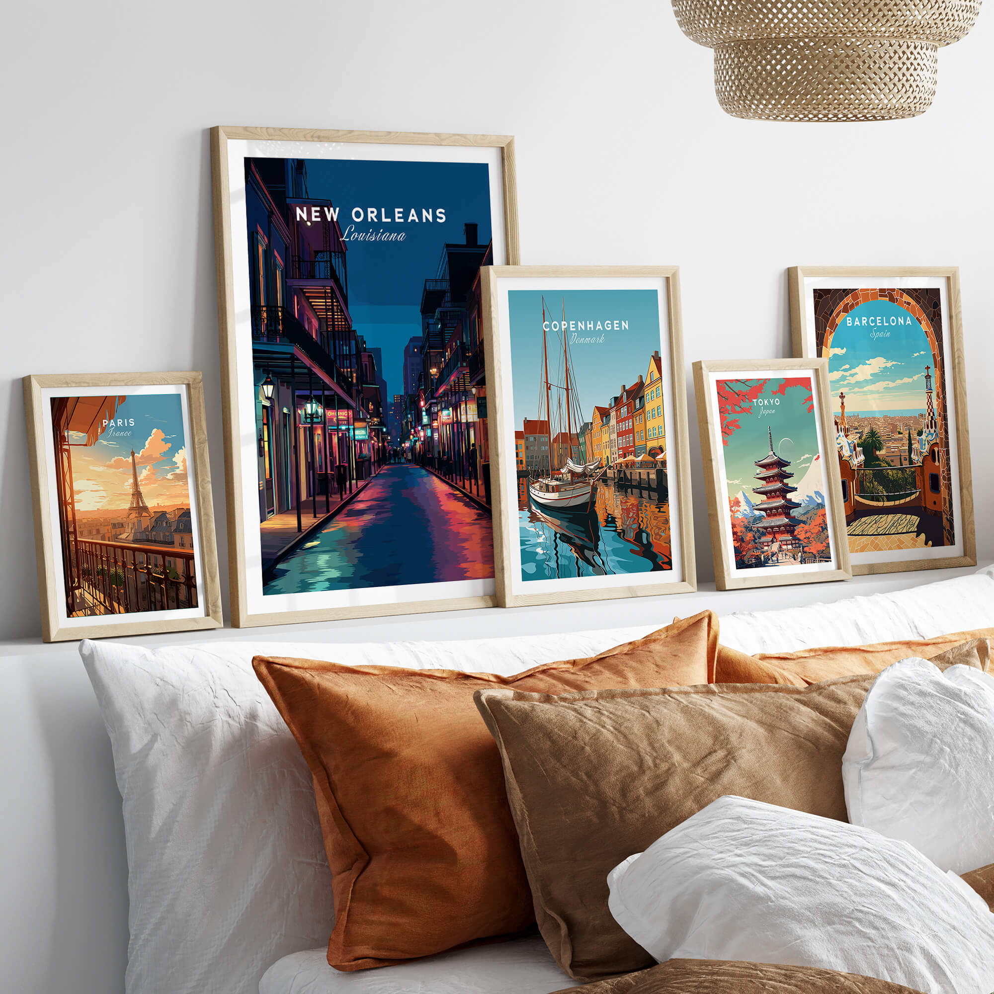 New Orleans Travel Poster | Bourbon Street Night Wall Art Print displayed among other city travel posters on a cozy sofa.