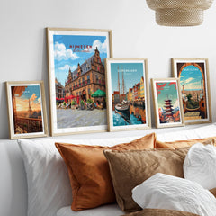 Framed travel posters of Nijmegen, Copenhagen, Paris, Tokyo, and Barcelona above a bed