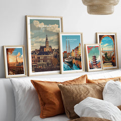 Travel posters in natural wood frames above bed, featuring city skylines and landmarks.