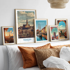 Set of five framed travel posters featuring city skylines above a bed with natural wood frames.