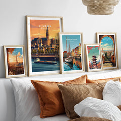 Framed travel posters of Nijmegen, Copenhagen, Tokyo, Paris, and Barcelona above bed