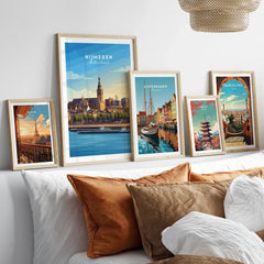 Framed travel posters of Paris, Nijmegen, Copenhagen, Tokyo, and Barcelona above a bed