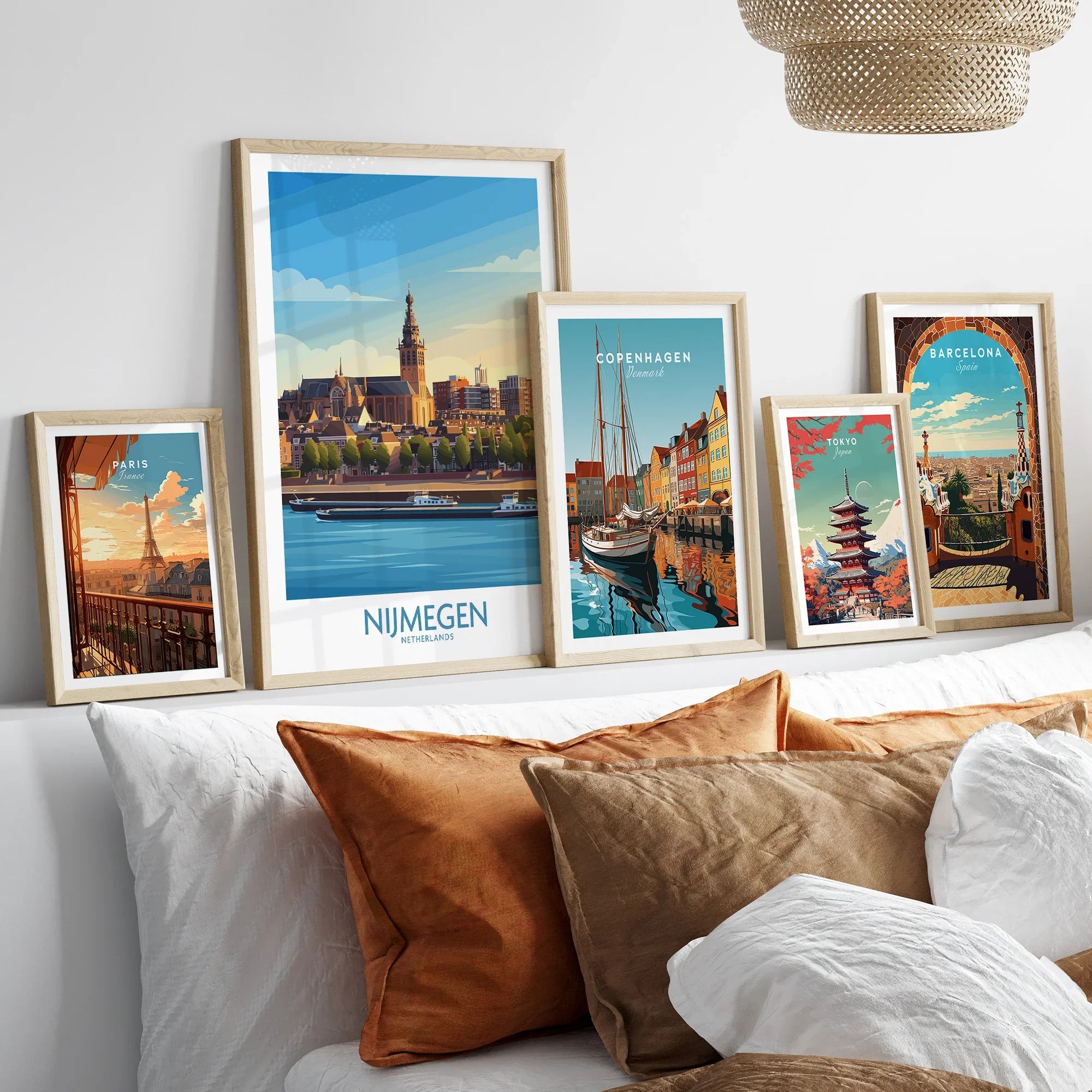 Framed travel posters for Paris, Nijmegen, Copenhagen, Tokyo, and Barcelona above a bed