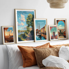 Set of five framed travel posters above a bed, featuring Paris, Richmond, Copenhagen, Tokyo, Barcelona landmarks.