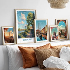 Travel city art prints in natural wood frames above bed with rustic pillows