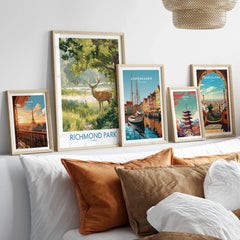 Framed travel and national park art prints above bed, featuring Paris, Richmond Park, Copenhagen, Tokyo, and Barcelona.