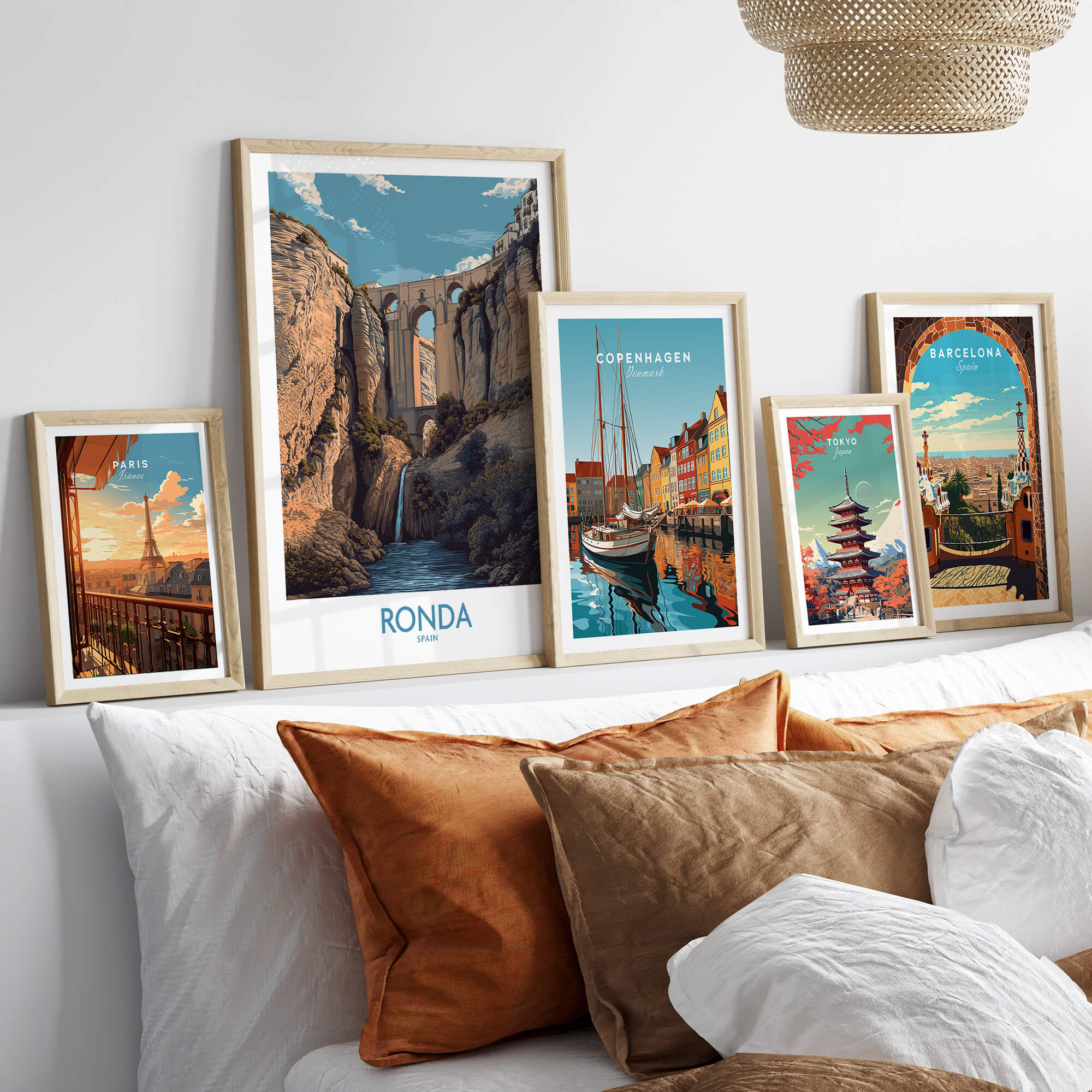 Ronda Spain Poster | Dramatic Andalusian Mountain Bridge Canvas Print displayed among other city posters on a cozy couch.