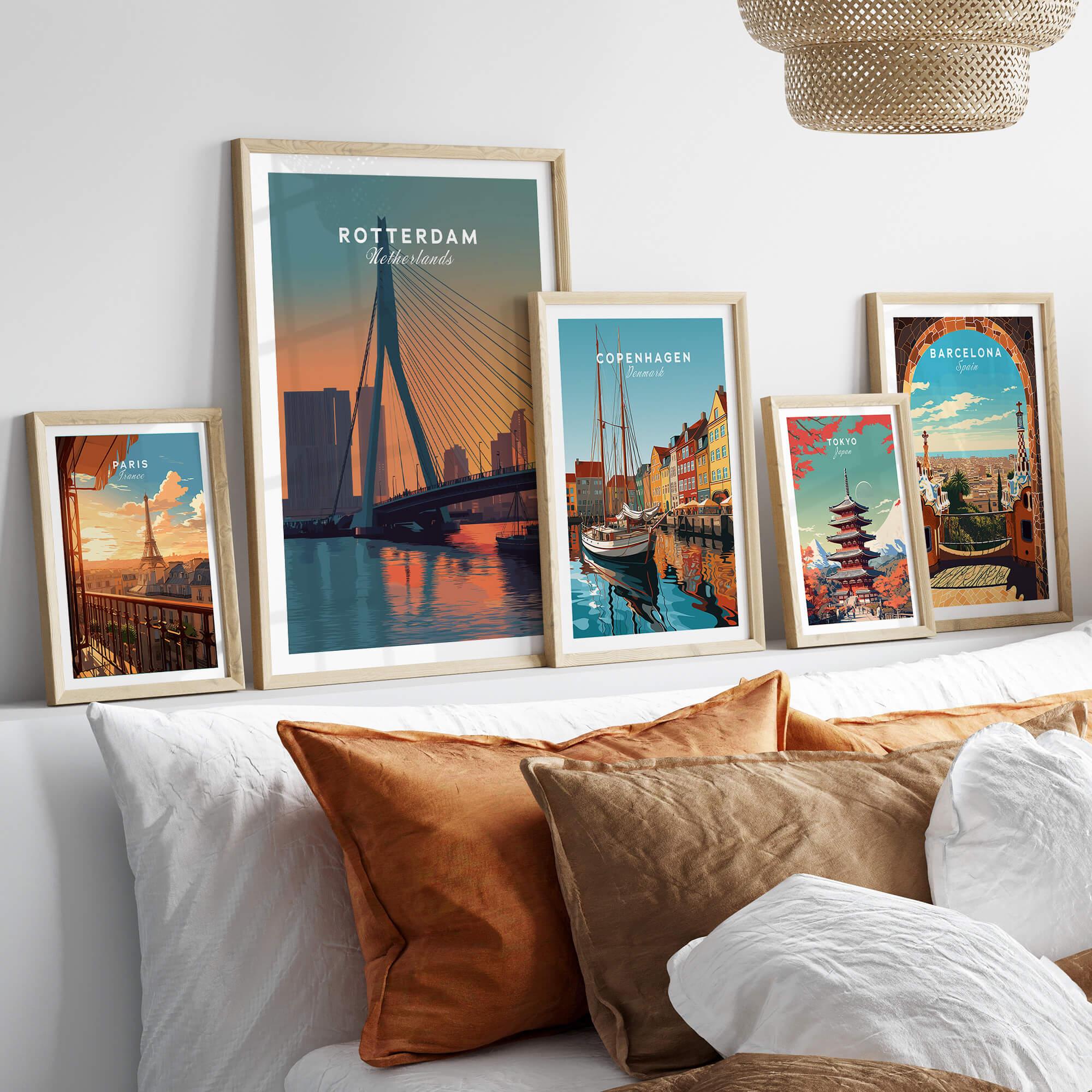Framed travel posters of Rotterdam, Copenhagen, Paris, Tokyo, and Barcelona above a bed