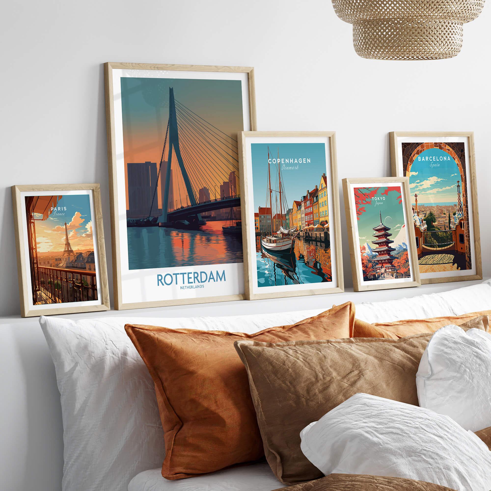 Set of five framed city travel posters above bed with natural wood frames, modern wall art