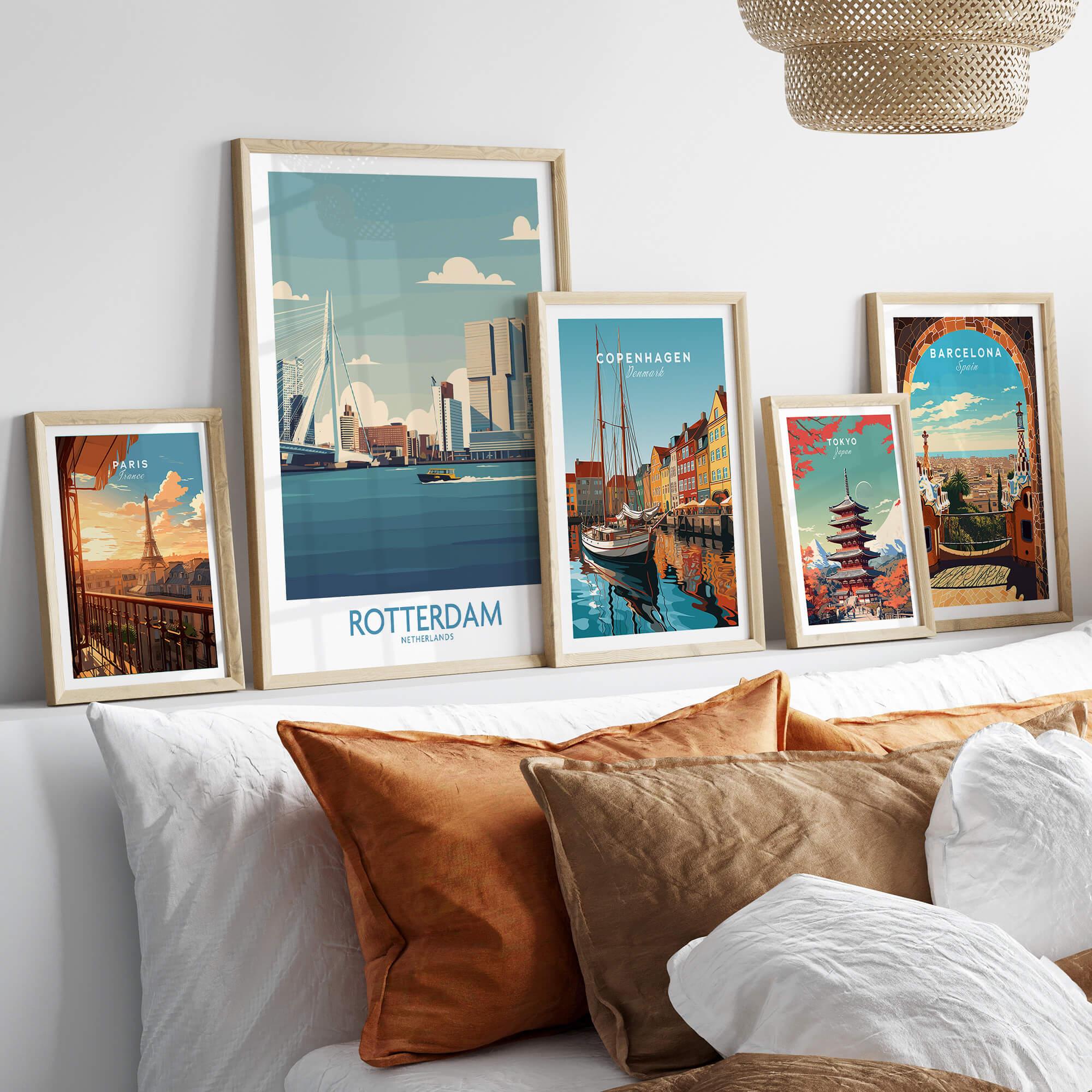 Framed travel posters of Rotterdam, Paris, Copenhagen, Tokyo, and Barcelona above a bed