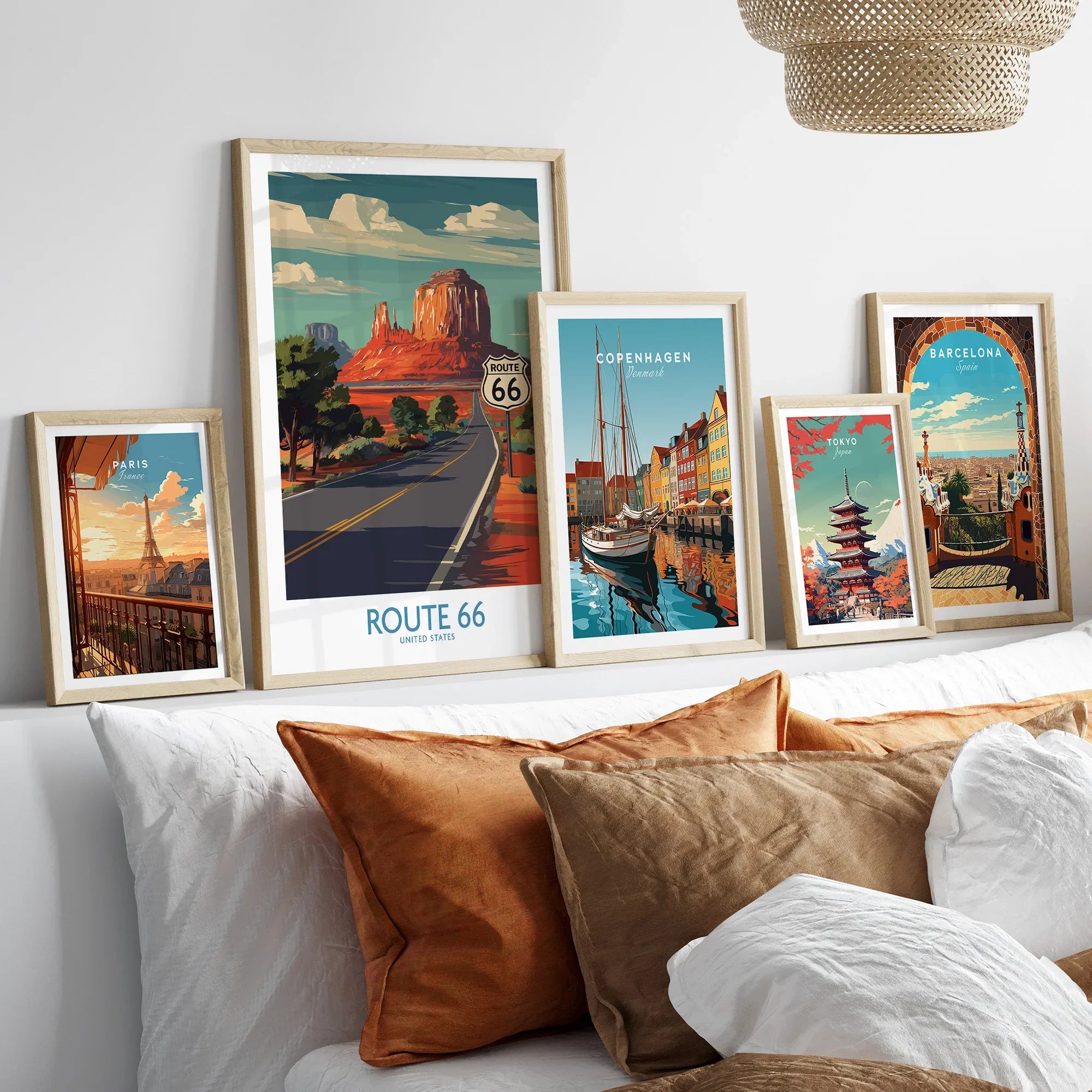 Framed travel art prints of Route 66, Paris, Copenhagen, Tokyo, and Barcelona above bed