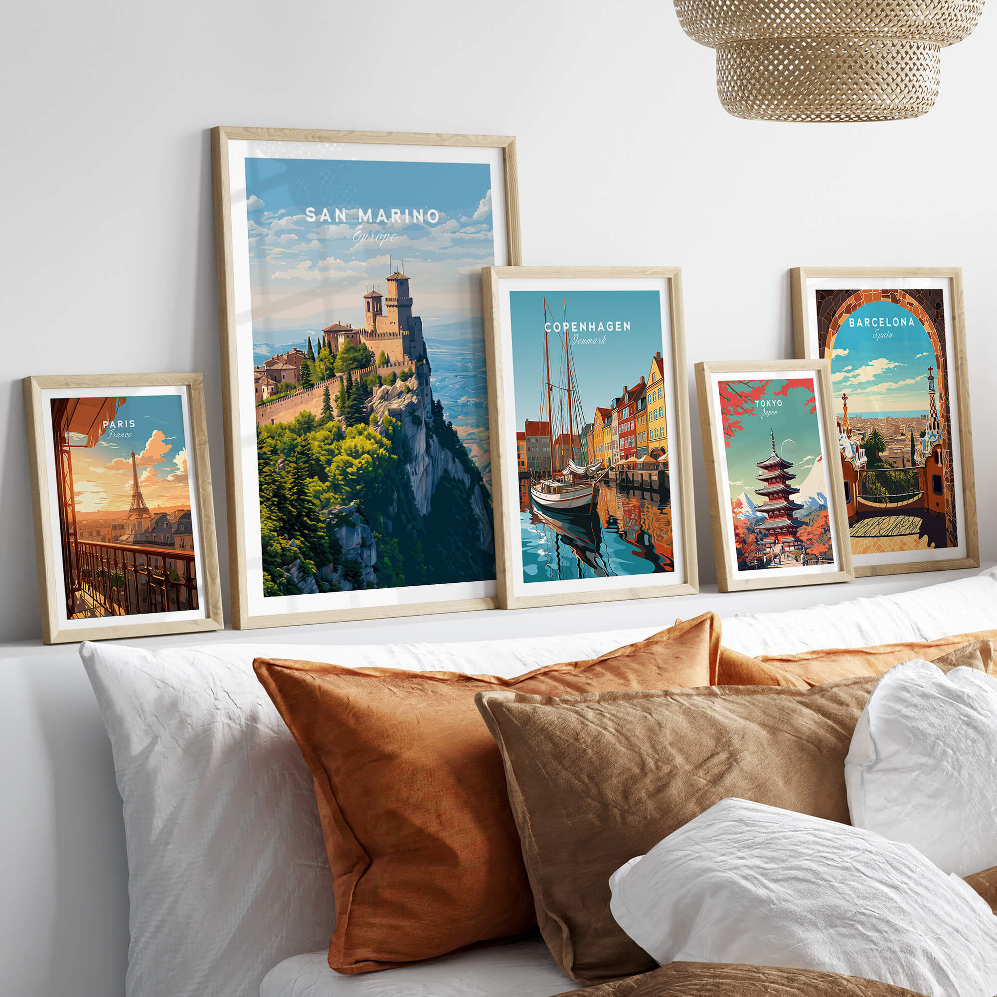 San Marino Wall Art Print | Mount Titano Citadel Travel Poster framed among other travel posters on a stylish sofa.