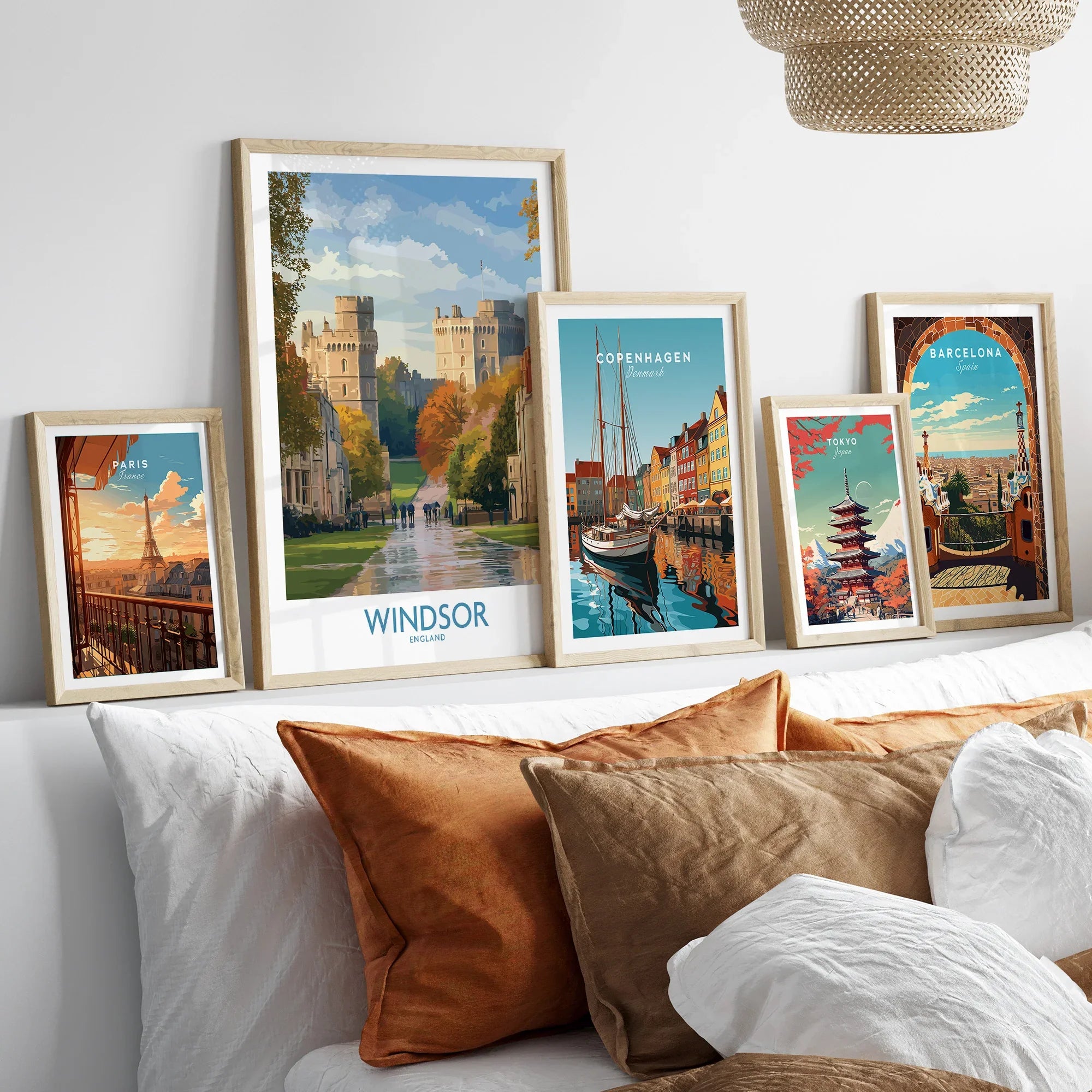 Set of five framed travel posters above bed, featuring Paris, Windsor, Copenhagen, Tokyo, Barcelona.
