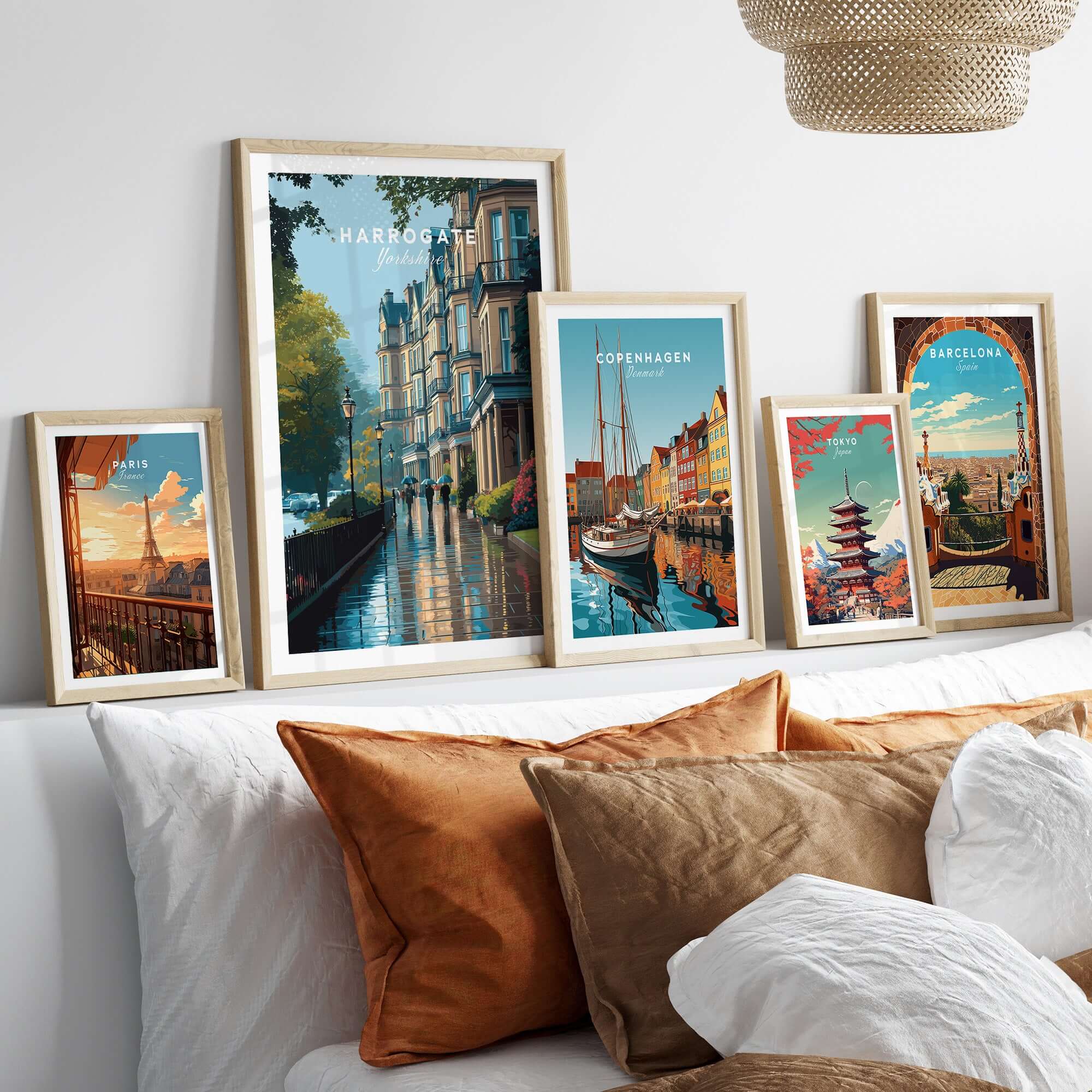 Harrogate Classic British Town Scene Print | English Architecture Wall Art displayed in stylish frames on a cozy sofa.