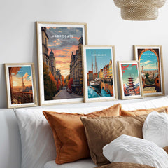 Harrogate Print | English Travel Wall Decor displayed in stylish frames on a cozy bed setting.