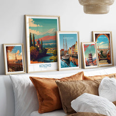 Kosovo Art Print | Snowy Mountain Balkan Poster displayed among various city-themed art prints on a stylish interior couch.
