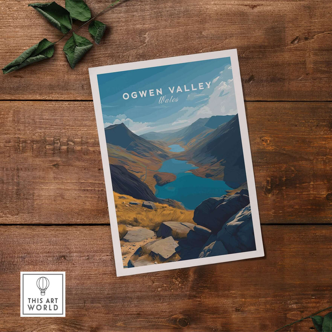 Ogwen Valley print showcasing Wales' mountain lakes and landscape, framed on wooden table.
