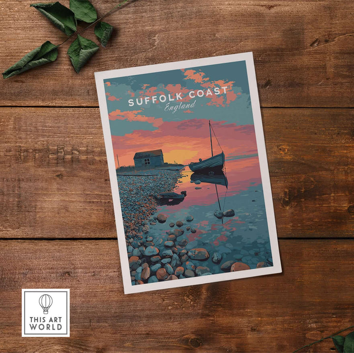 Suffolk Coast sunset print featuring a boat, coastal huts, and pebble beach on wooden background.