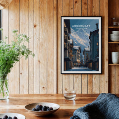 Andermatt Travel Poster – Swiss Alps Winter Village and Chalet Print displayed in a cozy wooden kitchen.