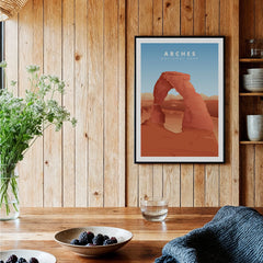 Framed Arches National Park travel poster hanging in a rustic wood kitchen setting