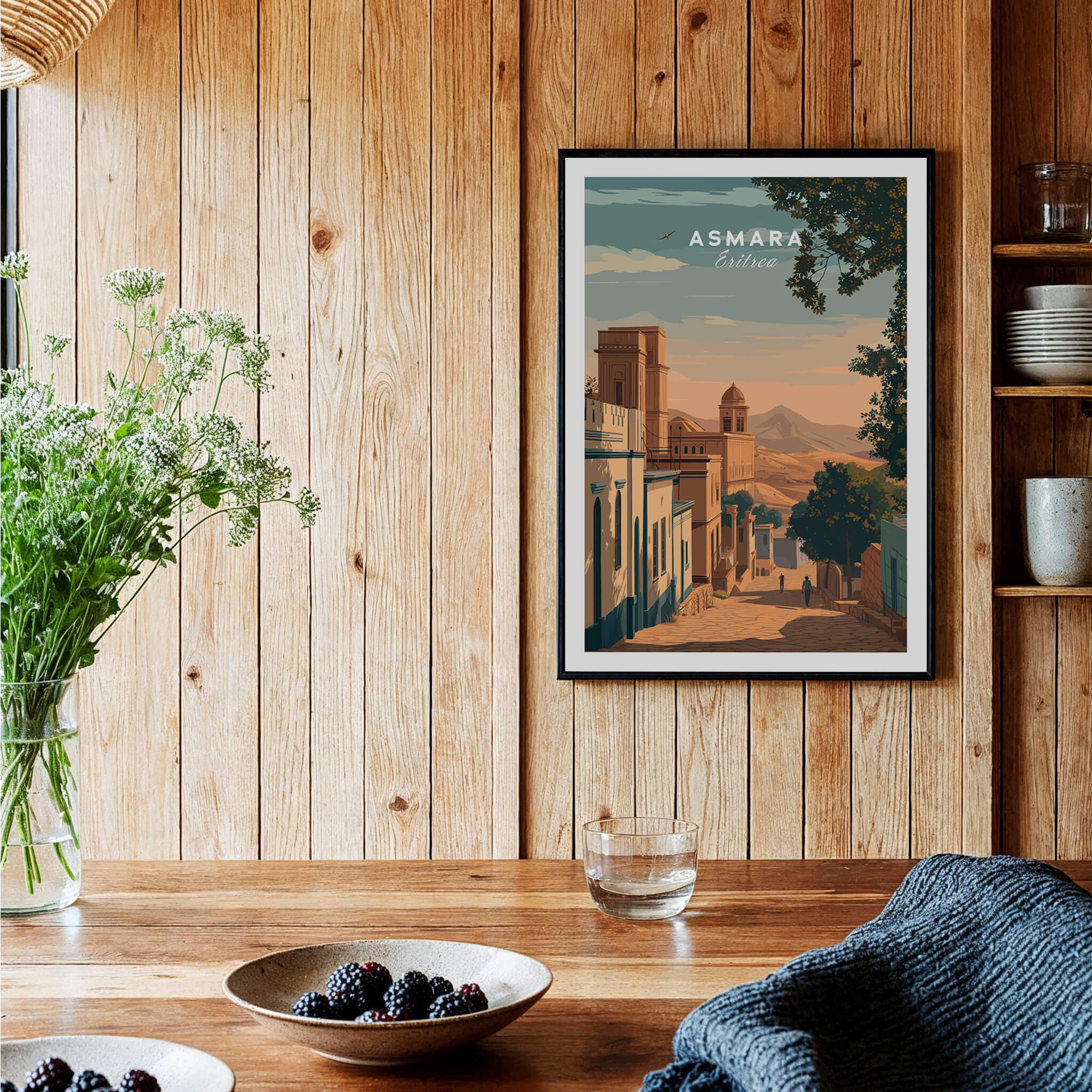 Asmara Travel Poster – Sunset Cityscape Art Print displayed in a cozy wooden interior with plants and tableware.
