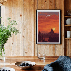 Bagan Travel Poster – Myanmar Ancient Temple Sunset Art framed on a wooden wall, showcasing a sunset over ancient pagodas.