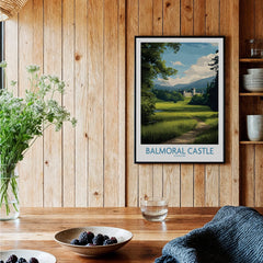 Balmoral Castle art print in black frame on wood wall, kitchen setting with rustic decor.