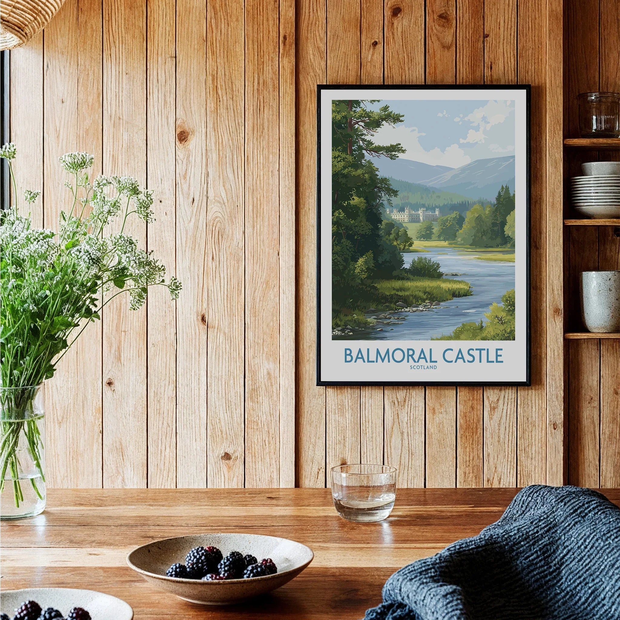 Framed Balmoral Castle travel poster on rustic wood kitchen wall with fruit bowls and flowers