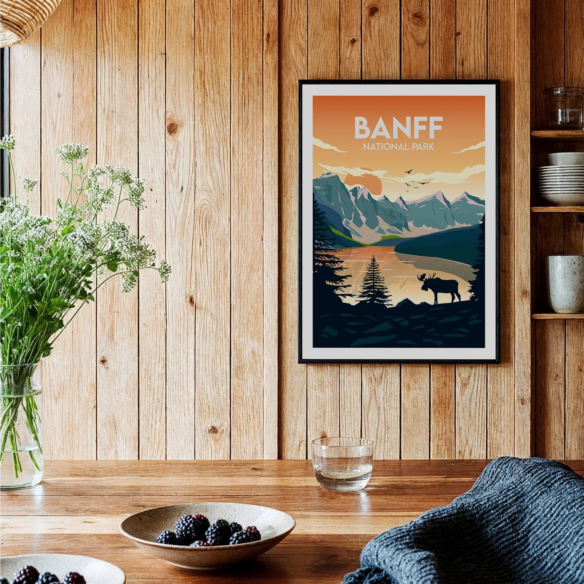 Banff National Park art print with moose and mountains in wood-paneled kitchen setting