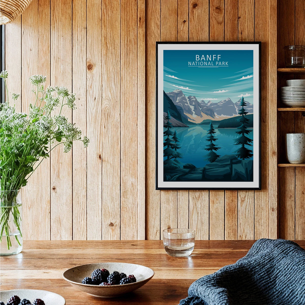 Framed Banff National Park art print in rustic kitchen with wood walls and fresh berries