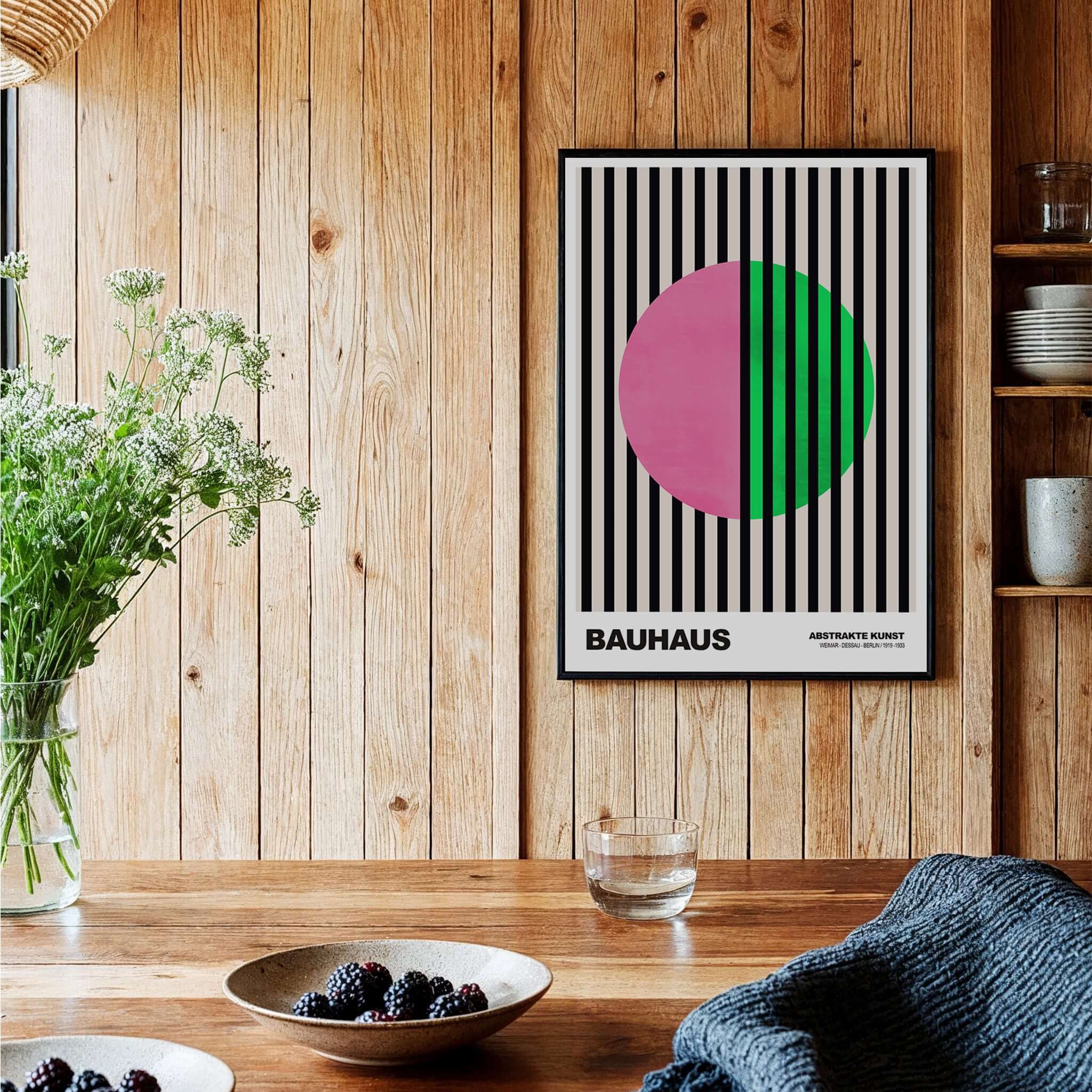 Bauhaus Exhibition Prints - Split Circle Abstract Art Print Pink Green Stripes displayed in a wooden interior with plants.