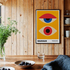 Bauhaus Exhibition Prints - Abstract Eyes Poster Geometric Orange Red Blue Art displayed in a cozy interior setting.