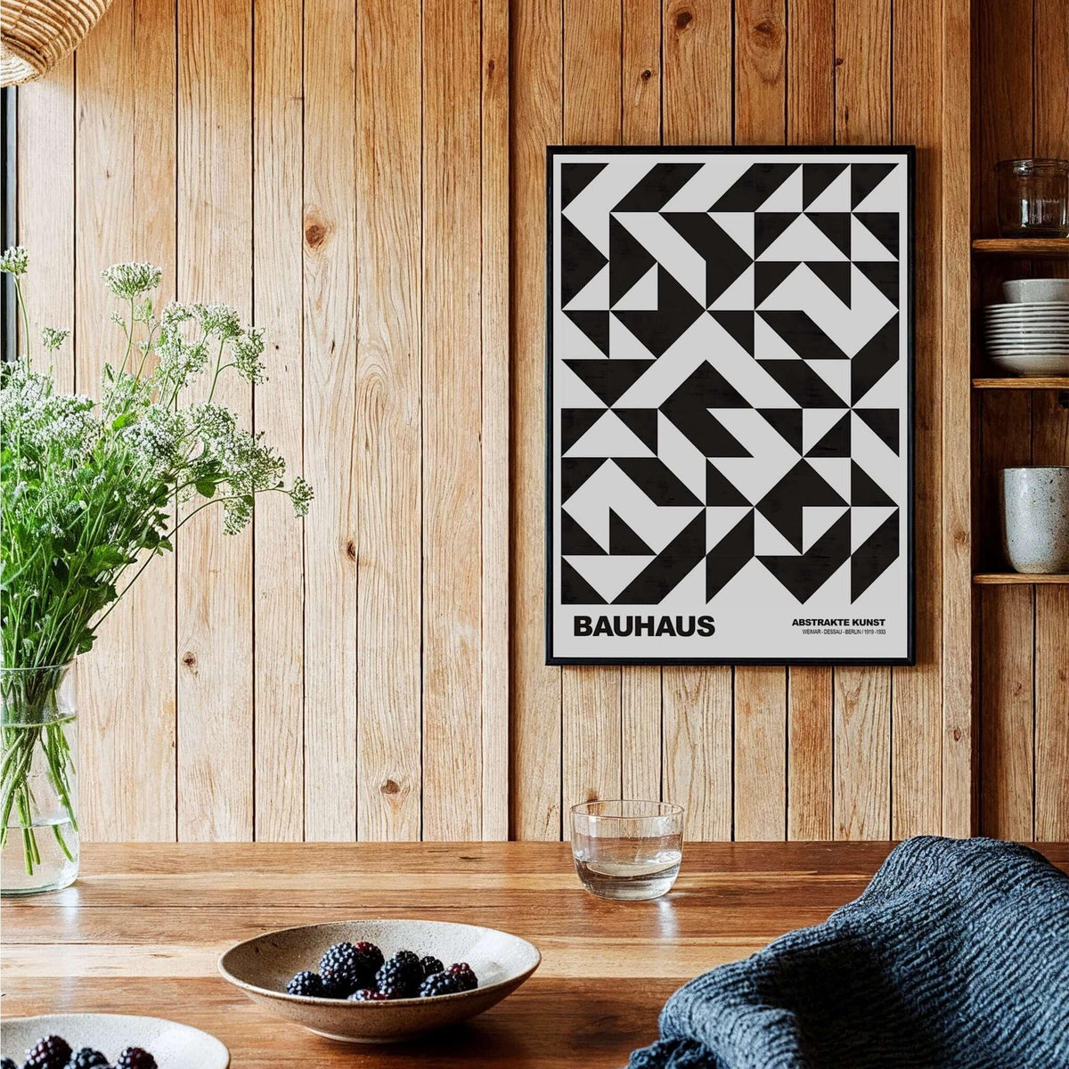 Bauhaus Exhibition Prints - Geometric Triangle Pattern Poster Black White Abstract hanging on a wooden wall with decorated table.