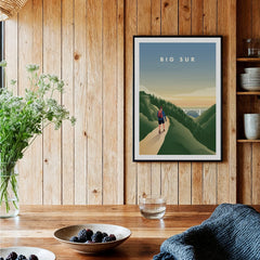 Big Sur travel poster art print with hiker, framed on wooden kitchen wall