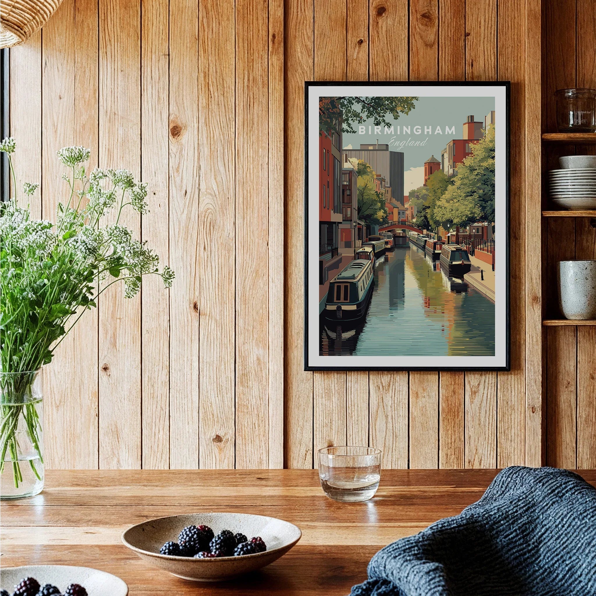 Framed Birmingham travel poster art print in modern kitchen with wood panel walls