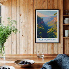 Framed Blue Mountains Australia art print hanging in rustic kitchen with wood panel walls.