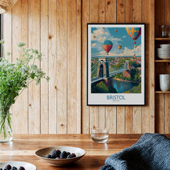 Bristol England Print – Hot Air Balloons Over Historic City Wall Art framed on a wooden wall with decorative elements.