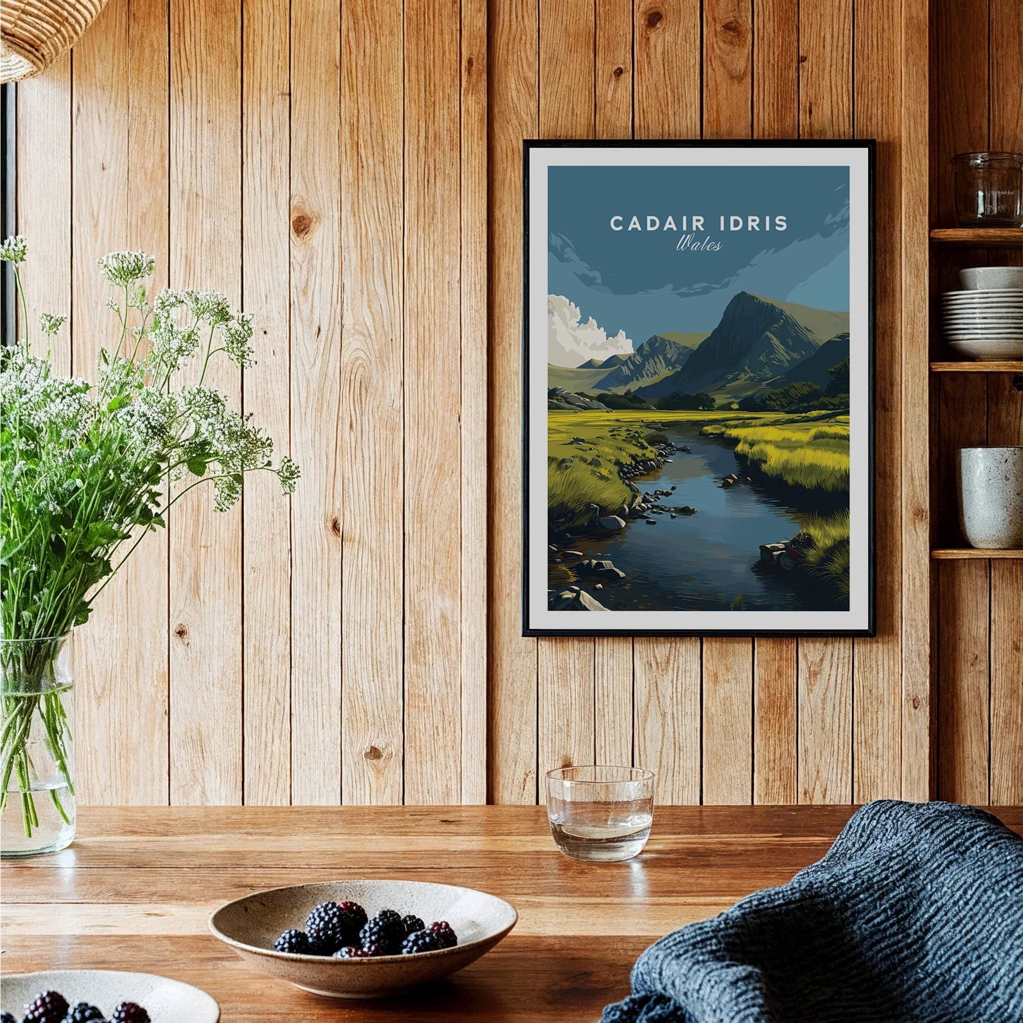Framed Cadair Idris travel poster print in rustic kitchen with wood paneling and natural decor