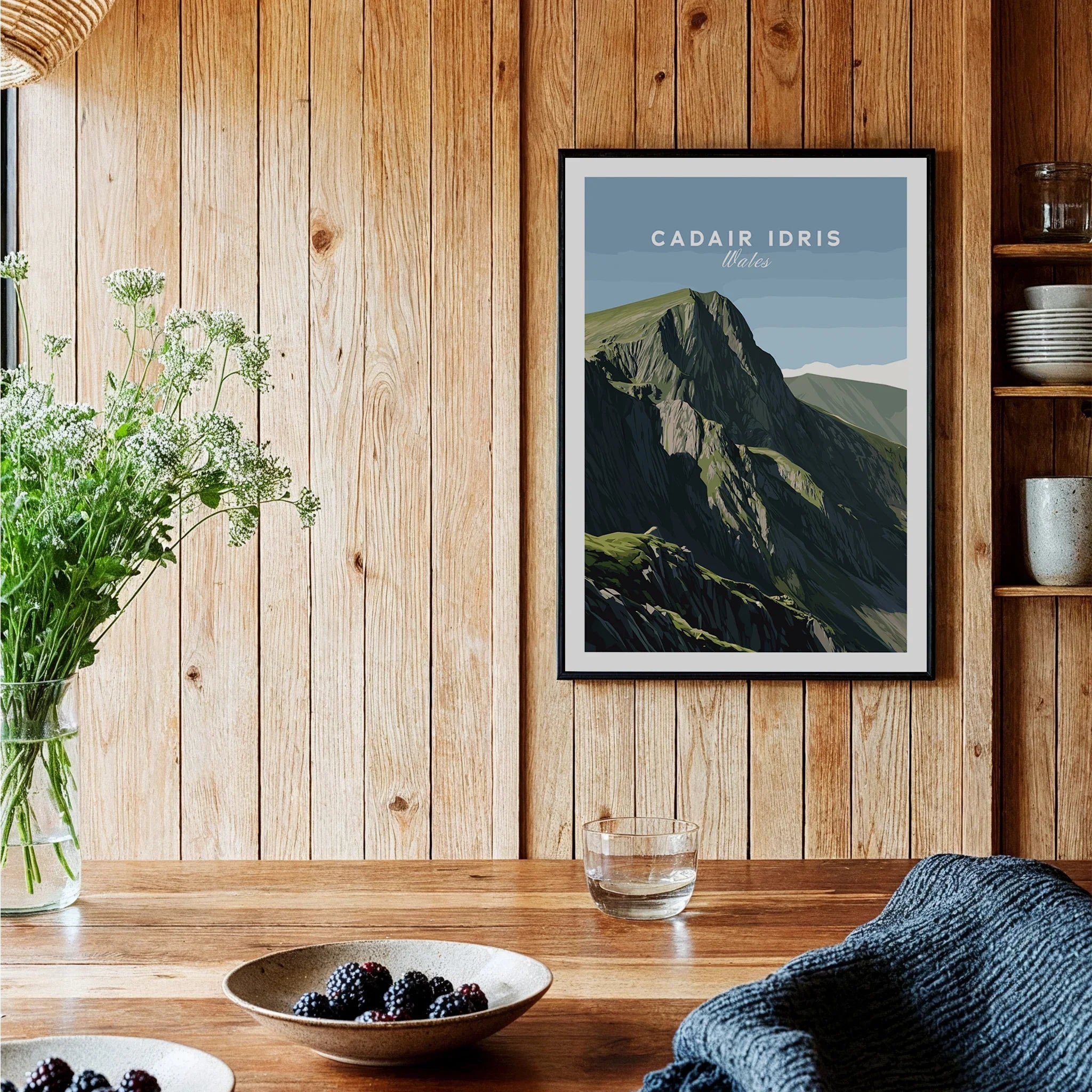 Cadair Idris Wales art print in black frame on wooden kitchen wall with bowls and flowers