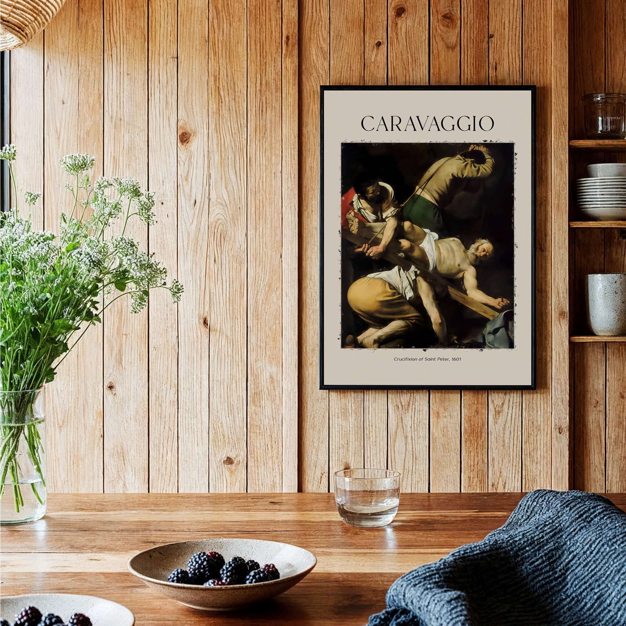 Caravaggio Art Print - Crucifixion of Saint Peter 1601 displayed on a wooden wall above a table with blackberries.