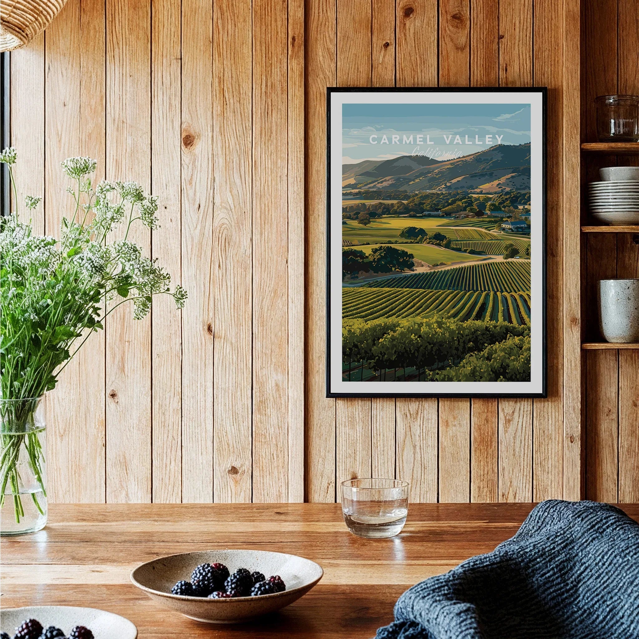 Carmel Valley travel poster art print in black frame on rustic wood kitchen wall