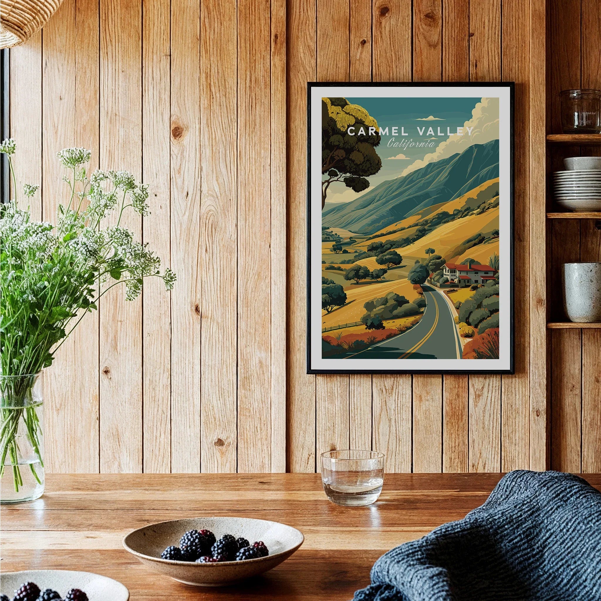 Framed Carmel Valley travel poster art print on wood kitchen wall with rustic decor.