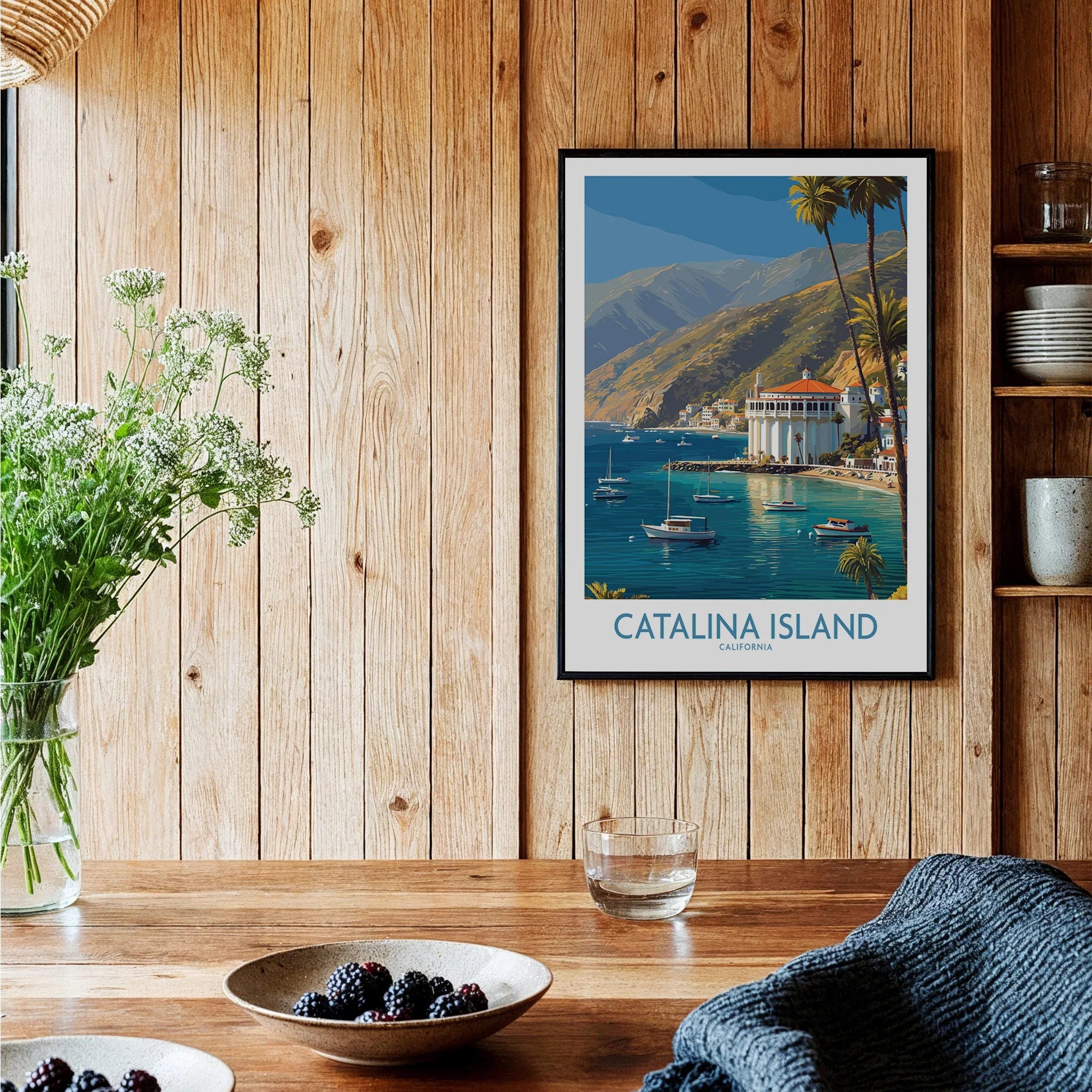 Catalina Island art print with colorful coastal scene in black frame on rustic kitchen wall