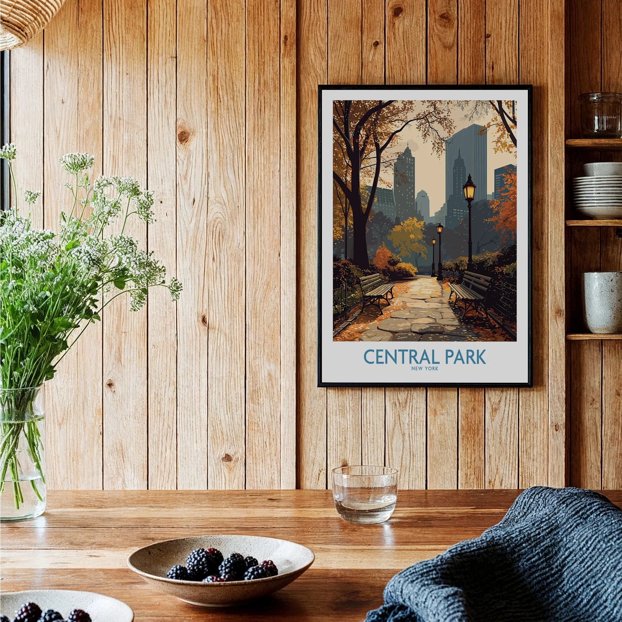 Central Park New York art print in black frame on wooden kitchen wall, with cozy decor