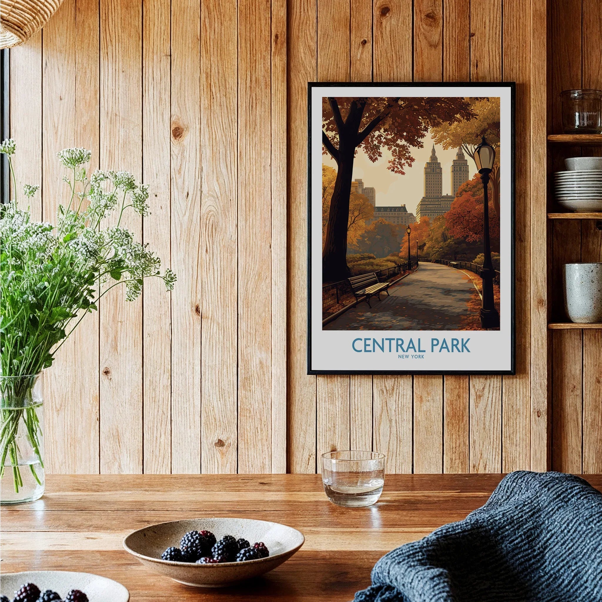 Central Park art print in black frame on wooden wall in cozy kitchen setting