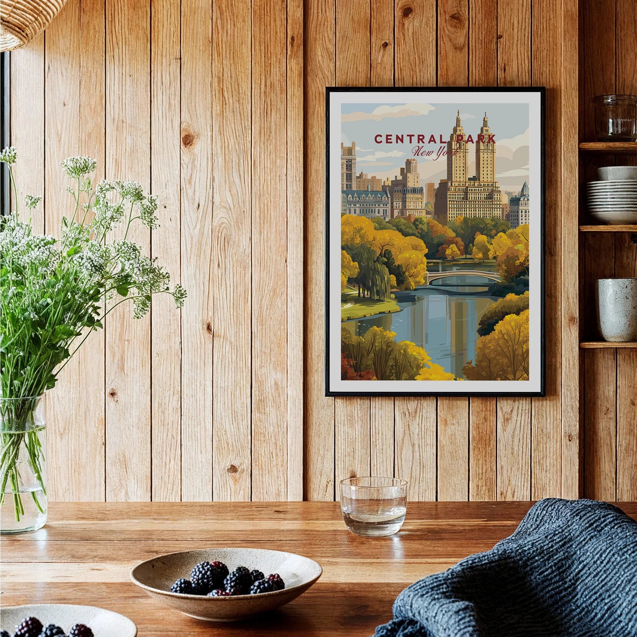 Central Park art print with city skyline in black frame, displayed in rustic kitchen setting